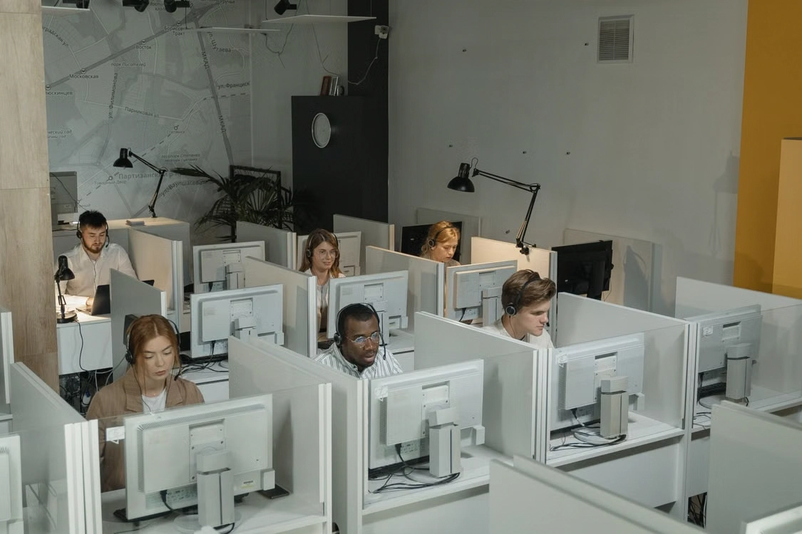 Customer service agents working in cubicles