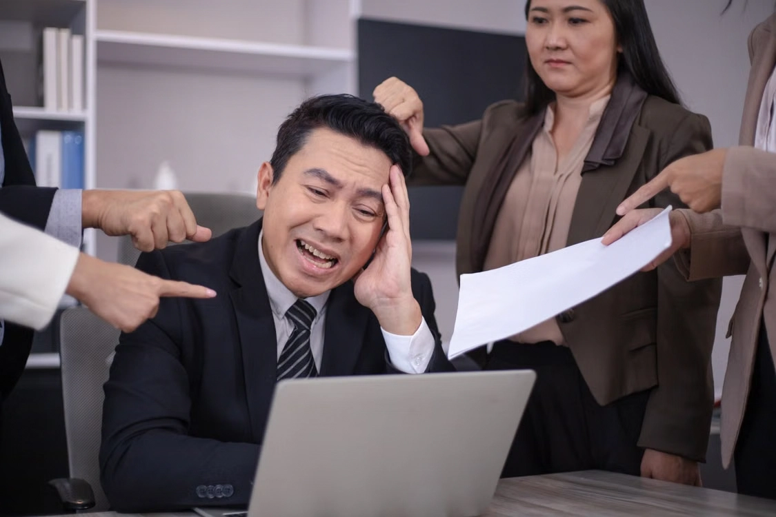 stressed-businessman-blamed-by-colleagues-at-office