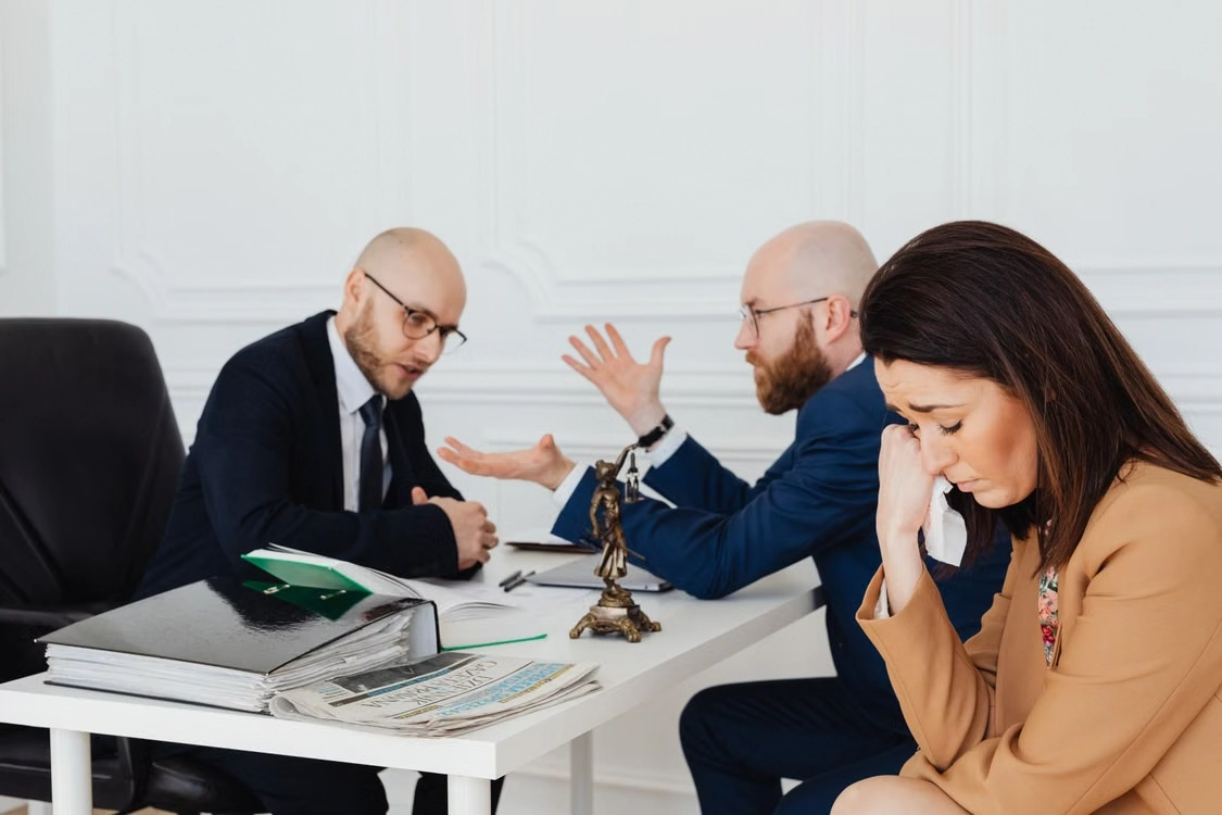upset-woman-during-a-legal-meeting-with-lawyers